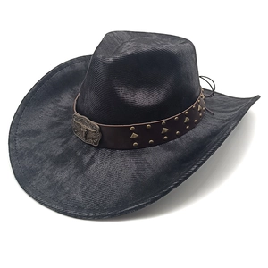 Detail of western cowboy hat with brown leather band and antique eagle metal buckle