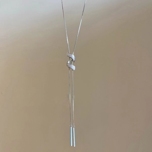 Dettaglio della collana a Y d'argento con pavé di zirconi e ciondolo a barra liscia