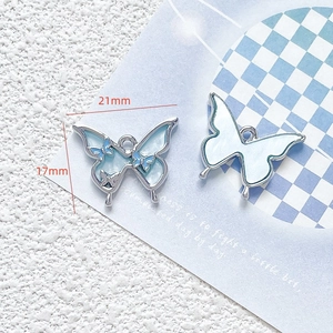 Blue alloy butterfly pendant for DIY jewelry with size measurements of 21mm by 17mm