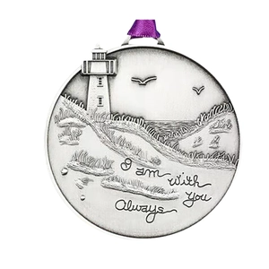 Silver tree of life pendant with lighthouse engraving and purple ribbon on white background