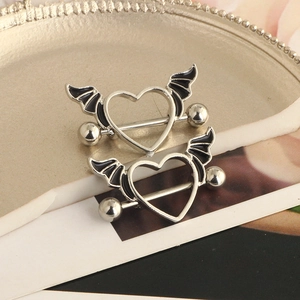 Detailed view of heart-shaped nipple rings featuring stylish black devil wing accents