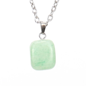 Detail of light green natural stone pendant with silver metallic chain on white surface