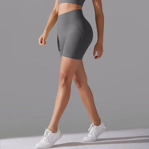 Detail of high-waist grey yoga shorts showing elastic fabric and side seam hip contours