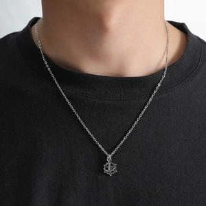 Men's stainless steel anchor and helm pendant necklace shown on model with black t-shirt