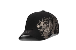 Detail of golden dragon print on premium black cotton baseball cap with curved brim