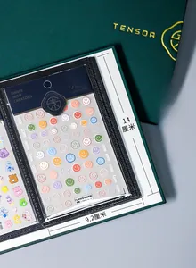 Close-up of 3D embossed macaron smiley nail stickers in a black leather display album