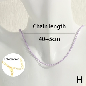 Detail of purple bead necklace featuring golden lobster clasp and 40+5cm adjustable chain