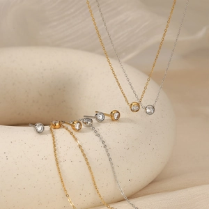 Elegant gold and silver jewelry set featuring round zircon necklaces and stud earrings