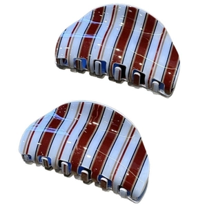 Detail view of blue and brown striped acetate hair claw clips for elegant updos