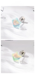 Detail view of colorful star stud earrings with iridescent aurora pearl finish