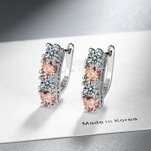 Macro shot of S925 silver hoop earrings with champagne and white zircon stones