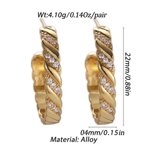 Detailed view of 18K gold plated twisted hoop earrings with sparkling zircon stones