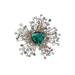 Luxury emerald crystal flower brooch with shimmering green gemstones on a white background