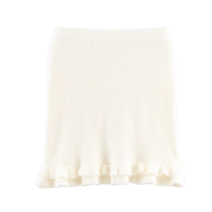 Detailed view of the fine knitted texture and ruffled hem on this white mini skirt