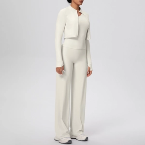 Detailed shot of ivory three-piece yoga set with zip jacket, vest and wide-leg pants