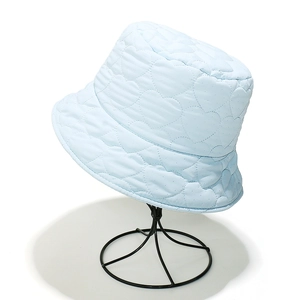 Close-up of quilted heart pattern texture on light blue padded bucket hat