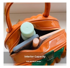 Detail view of pumpkin handbag interior capacity for cosmetics and mobile phone
