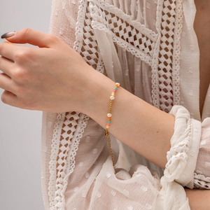 Colorful crystal bead and pearl bracelet with gold adjustable chain on woman's wrist