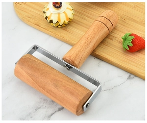 Beech wood pastry roller on marble counter with cupcake and fresh strawberry
