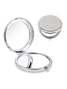 Detail of silver bridesmaid compact mirror with floral engraving and folding dual sides