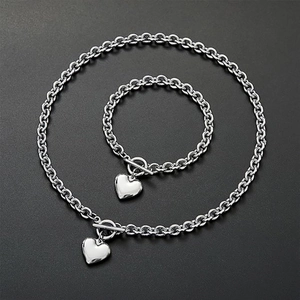 Polished silver stainless steel O-chain jewelry set with heart pendants and toggle clasps