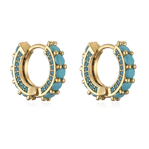 Detailed view of gold hoop earrings with turquoise beads and delicate metal granulation
