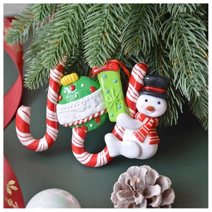 Detailed close-up of JOY polymer clay ornament with snowman and candy cane elements