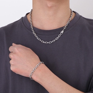 Men's silver stainless steel chain necklace and bracelet set shown on model