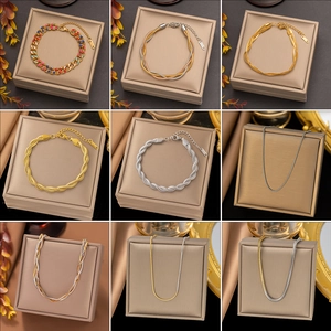 Various styles of 18k gold-plated stainless steel necklaces and bracelets in jewelry boxes
