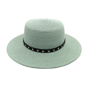 Détail du chapeau de paille vert menthe montrant le tissage fin et le ruban à rivets