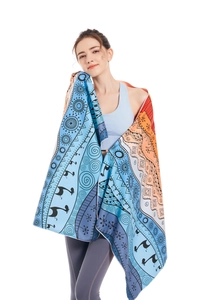 Microfiber beach towel detail showing bohemian patterns and soft texture on model