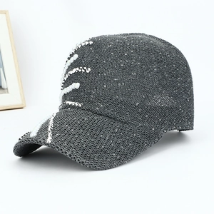 Detail of dark grey sequined baseball cap with white pearl and stud embellishments