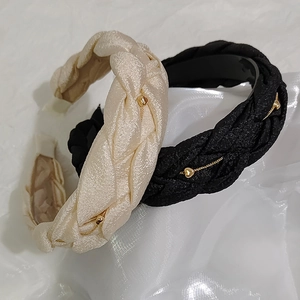 Elegant woven headband with gold heart chain detail in beige and black satin silk