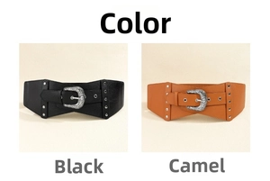 Detail of vintage carved buckle and silver rivets on a wide elastic waist belt