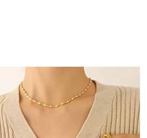 Detail of elegant 18K gold plated minimalist necklace with round white pearls