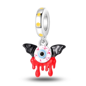 Macro detail of silver eyeball pendant with black bat wings and red dripping blood