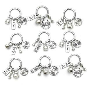 Silver fitness keychain set with dumbbells kettlebells and barbell weight plates for gym lovers