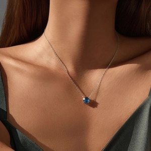 Elegant S925 silver necklace with a sapphire blue rose-cut pendant worn by a model
