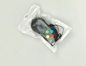 Detail of black fidget controller toy with four colored buttons and lanyard in packaging