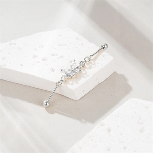 Detailed view of S925 silver industrial barbell earring with a sparkling butterfly charm