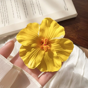 Macro detail of Frangipani hair clip with matte yellow petals and textured stamens