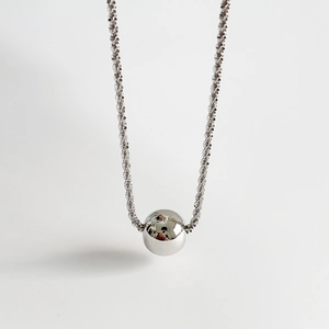 Polished silver sphere pendant necklace with shimmering twisted rope chain on white background