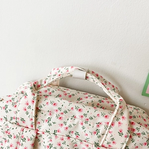Close-up of floral backpack with pink tulips and reinforced stitching details