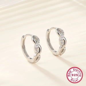 Macro shot of 925 sterling silver twisted hoop earrings with white cubic zirconia