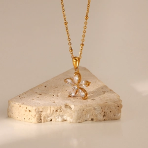 18K gold plated flower necklace with a 16mm white zircon pendant on natural rock texture