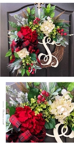 Detail of Christmas wreath with red hydrangea, pine needles, and plaid bow decoration