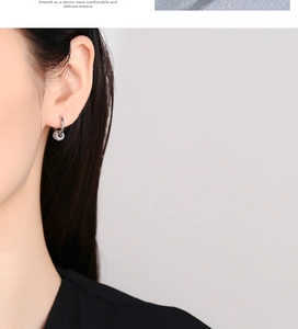 Close-up of a 925 sterling silver hoop earring with a shimmering micro-pave textured ball