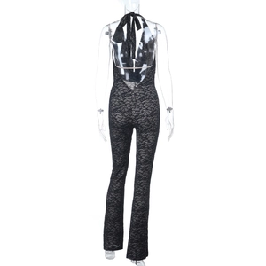 Detail of black lace jumpsuit showing backless halter neck design and sheer texture
