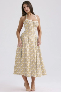 Detail of lace neckline and yellow floral print on a slim fit halter neck summer dress