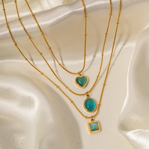 Three-piece gold ball chain necklaces with blue-green square and heart stone pendants